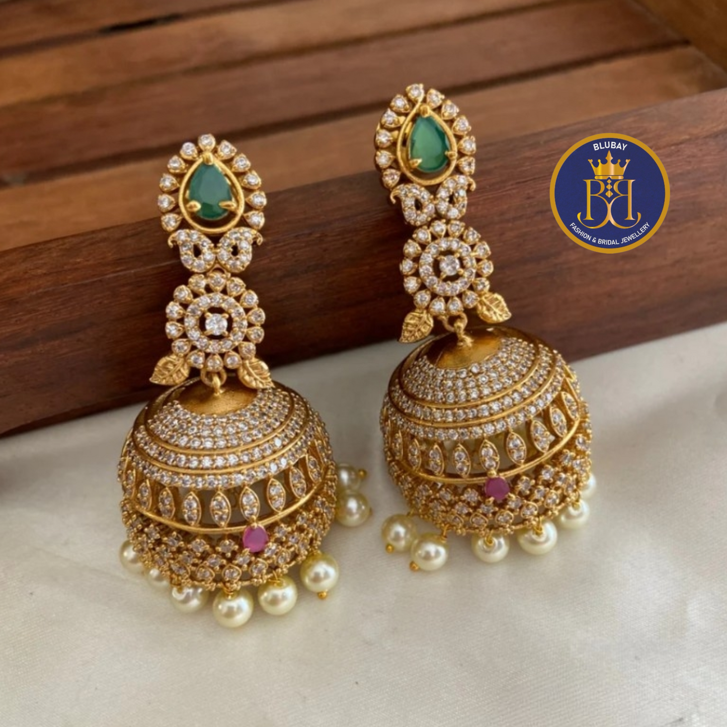 AD extravagant ruby and emerald gold plated premium mango Jhumkas