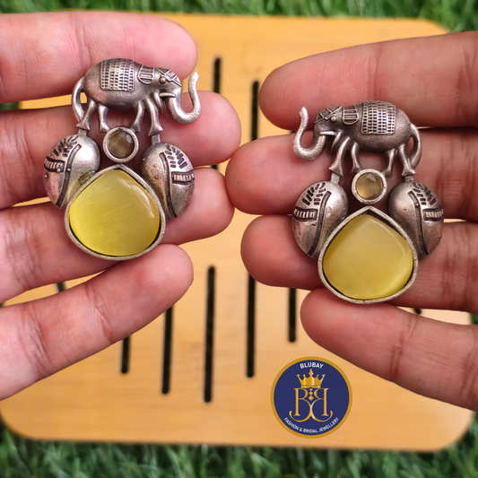 Silver haathi yellow stone studded earrings