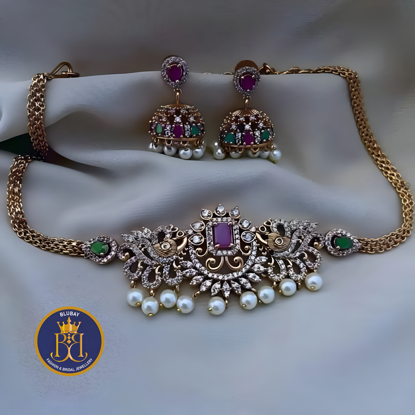 Premium AD with Ruby and emerald studded golden attigai Choker set with pearls